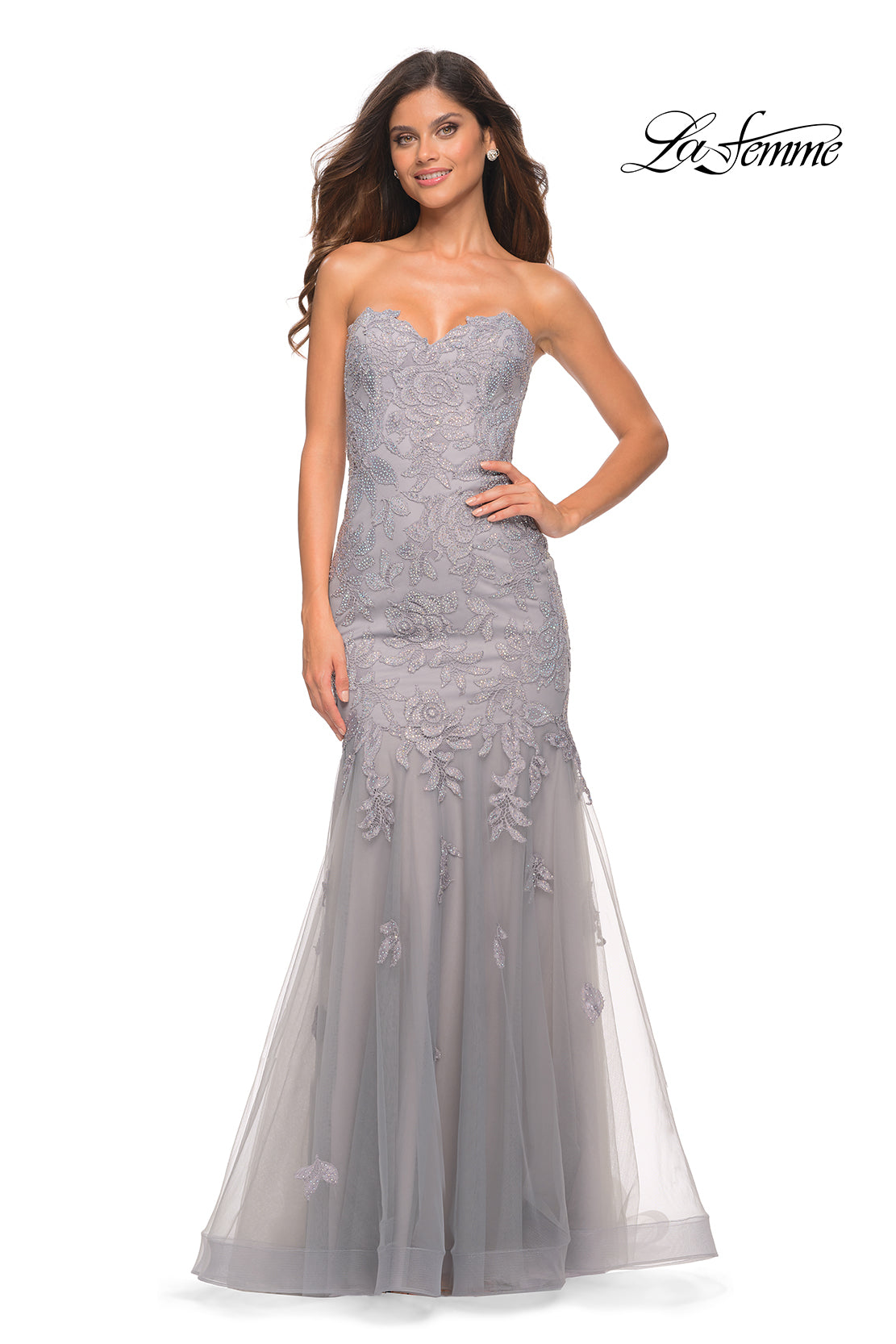 Model in Sheer-Back La Femme Strapless Mermaid Prom Dress—grey lace, floral embroidery, corset back, and flowing tulle skirt. La Femme logo top right.